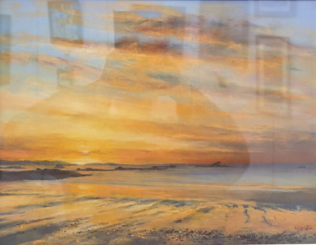 Pastel artwork titled ‘Vazon Sunset’ by Wendy Griffin, featuring soft orange hues blending into blue and grey tones, capturing a tranquil low-tide scene on a still evening. Framed, 425x510mm, available for £390.